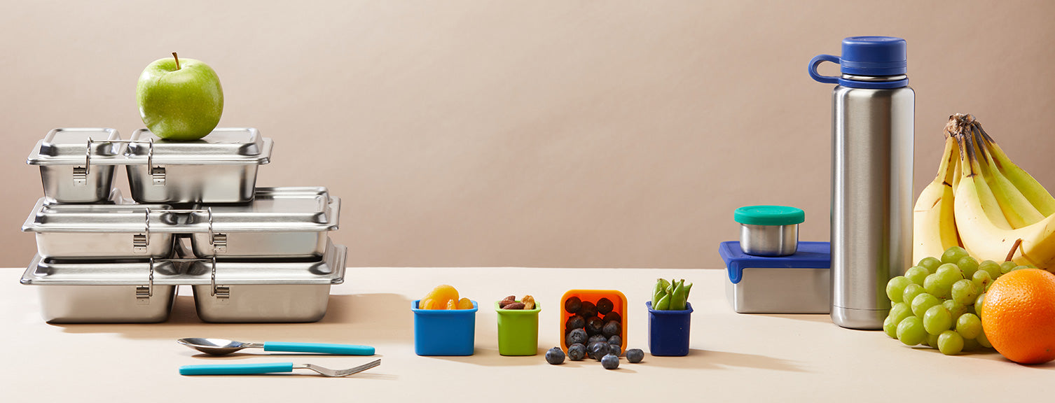 Array of PlanetBox products including: Rover, Launch and Shuttle lunchboxes, stainless steel water bottle and silicone snack pods.