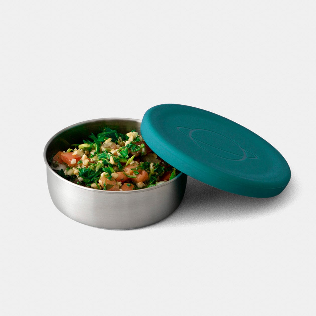 Stainless steel sauce container with teal silicone lid on white background