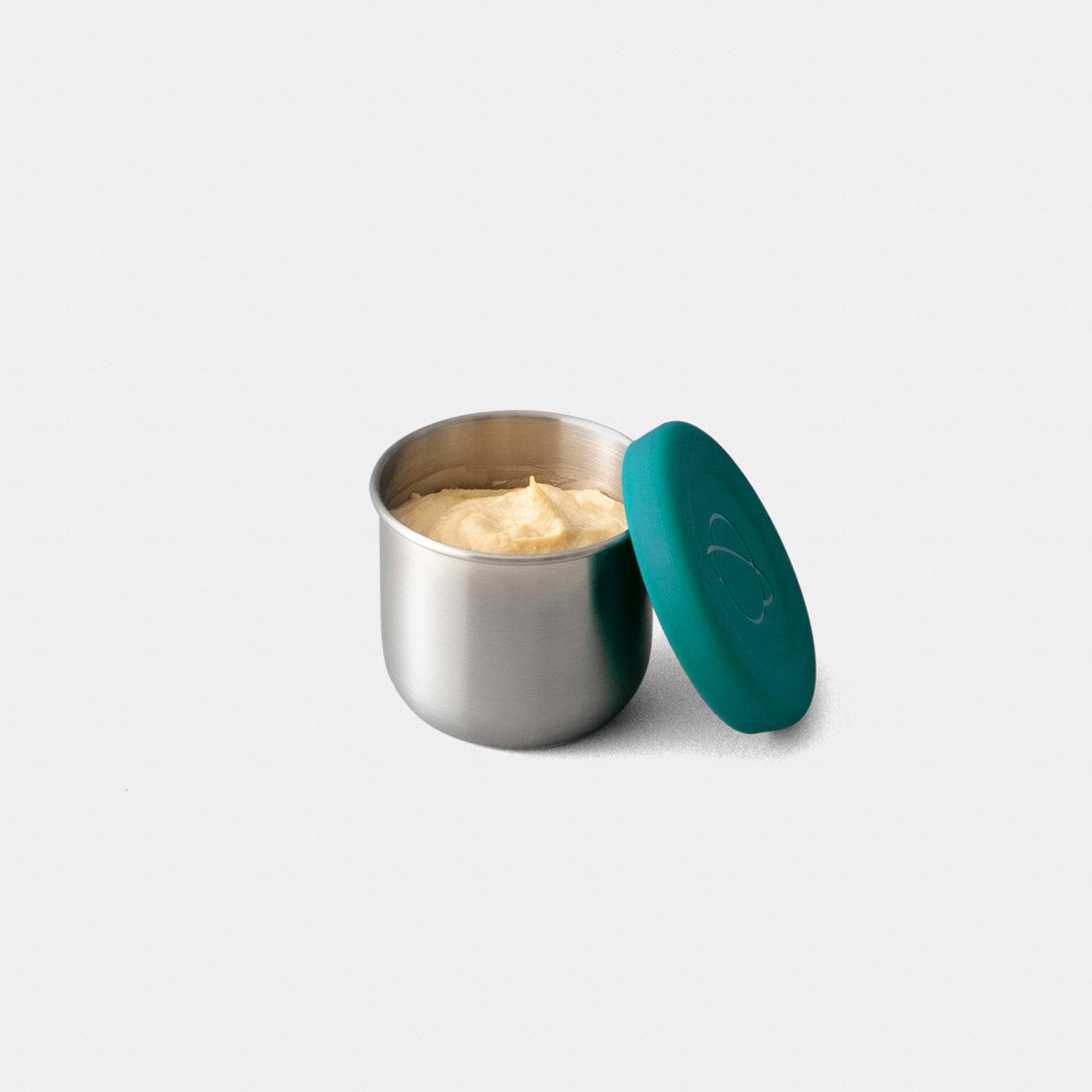 Tall dipper made to fit in Shuttle/Launch lunchboxes filled with hummus on grey background