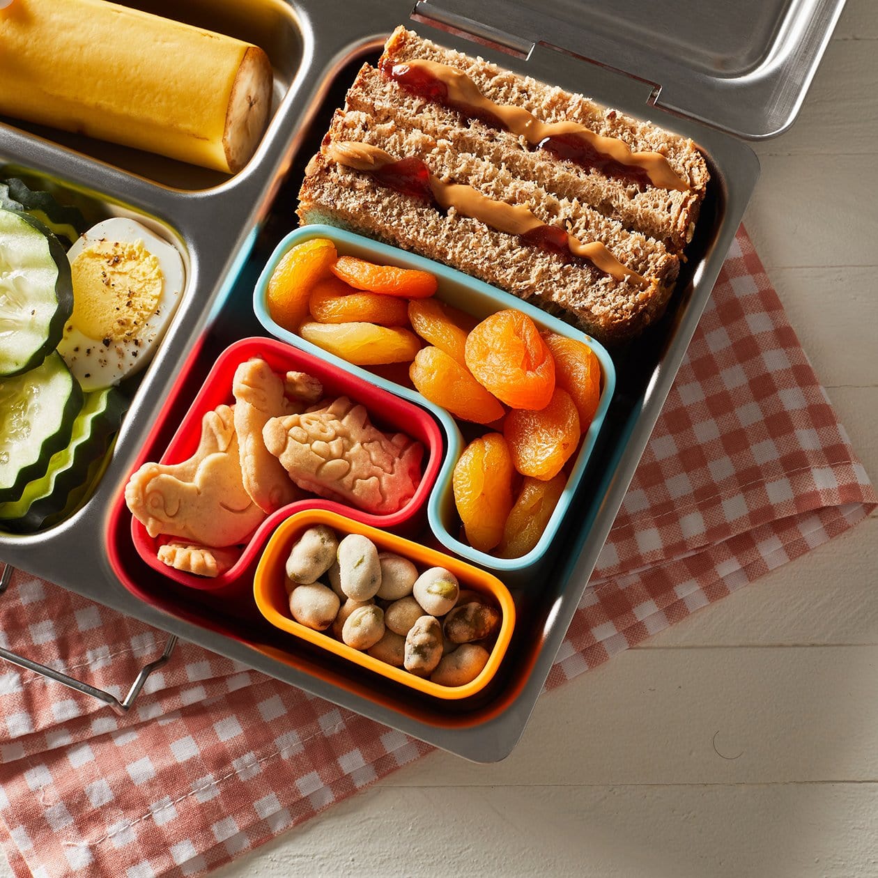 Puzzle Pods in PlanetBox Shuttle lunchbox filled with snacks.