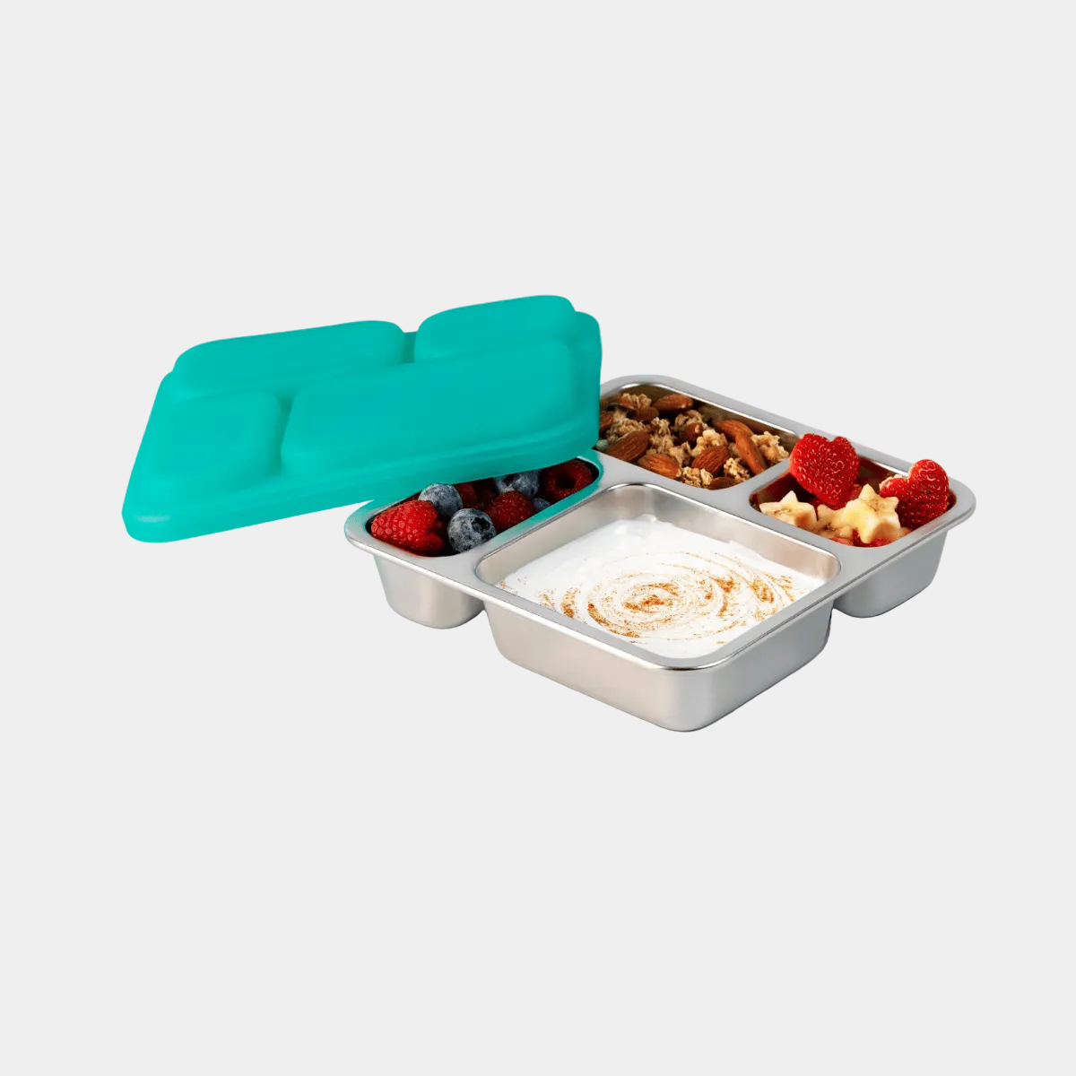 Metal lunch box with compartments filled with food and a teal lid on a white background