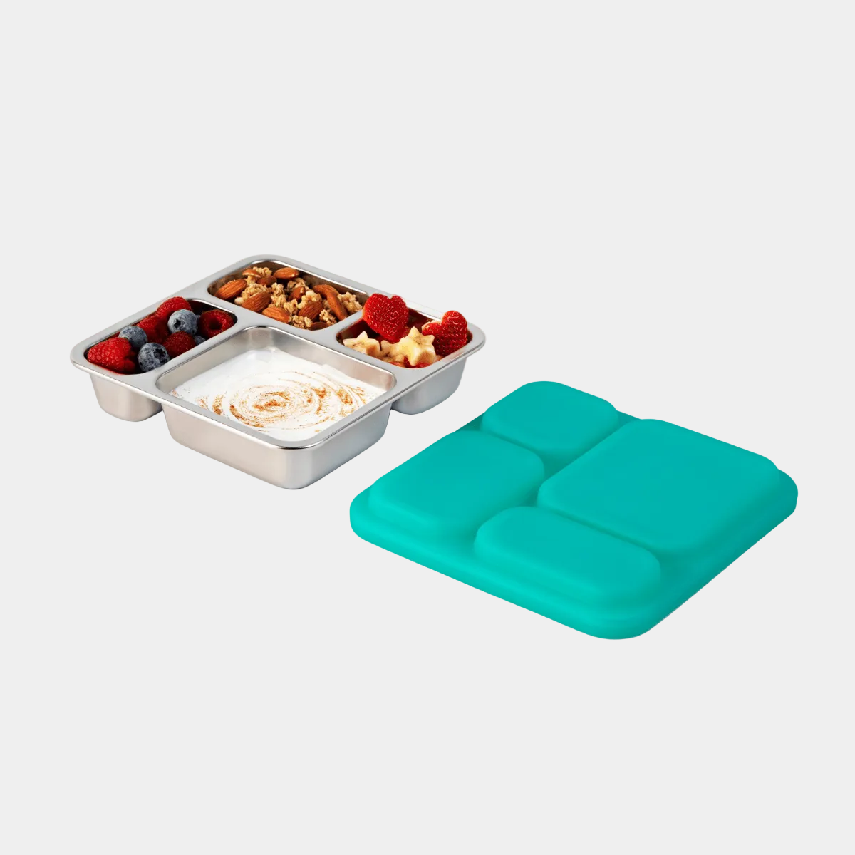 Voyager lunch box with compartments filled with food next to a turquoise lid on a white background