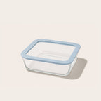 Square glass storage container with light blue lid on a kitchen counter